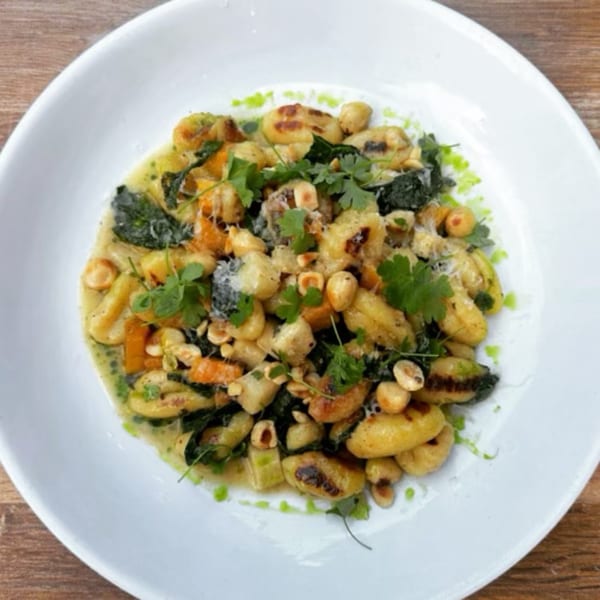 Mercato's gnocchi with roasted butternut squash, kale, hazelnuts, and fresh parsley in a creamy sauce.